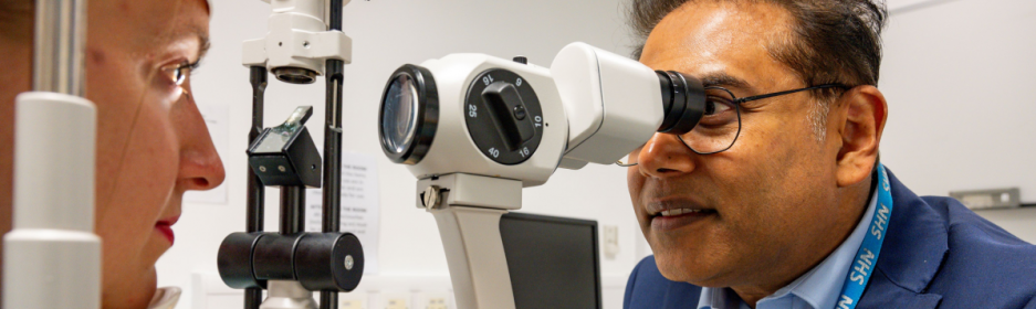 Ophthalmologist looking at patient eyes 