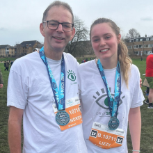 Smiling runners at the end of a race with medals 