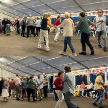 People dancing at a barn dance / hoedown holding hands