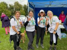 Four ladies - Jennie, Helena, Naomi and Beccy wearing Gift of Sight t-shirts and showing their medals at the finish line 