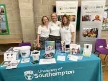 Ellie, Ailsa and Jennie in front of University of Southampton table 